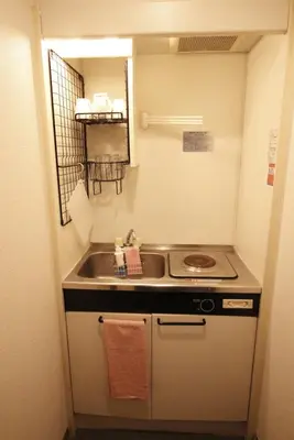 a small kitchen with a sink and a stove at Central Field 4F in Tokyo