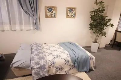 a bedroom with a bed and a potted plant at Central Field 4F in Tokyo