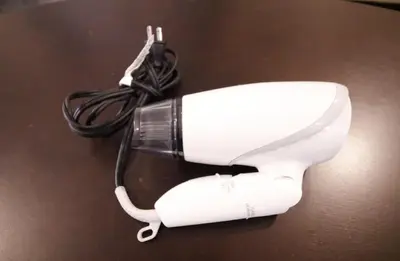 a white hair dryer sitting on a table at Central Field 4F in Tokyo