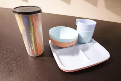 a table with a container and a cup on a tray at Central Field 4F in Tokyo