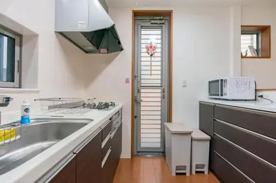 a kitchen with a sink and a microwave at Shinjuku-ku - House / Vacation STAY 3185 in Tokyo