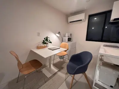 a small room with a desk and two chairs at Oku-Shibu Residence in Tokyo