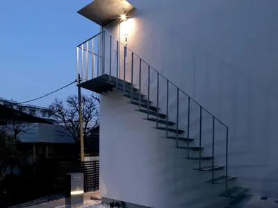 a staircase with a light on the side of a building at Oku-Shibu Residence in Tokyo