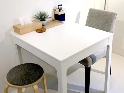 a white desk with two chairs next to it at Oku-Shibu Residence in Tokyo