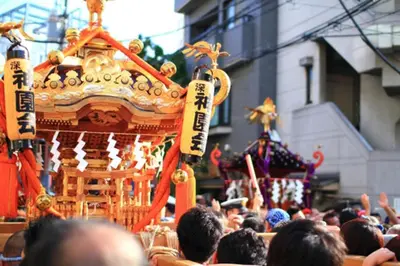 a crowd of people standing in front of a carnival at Oku-Shibu Residence in Tokyo