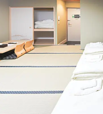 a hospital room with two beds and a closet at Akihabara Nakagawa Inn in Tokyo