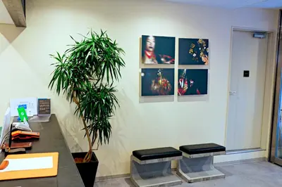 an office with two stools and pictures on the wall at Akihabara Nakagawa Inn in Tokyo