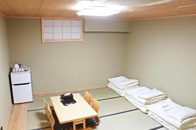 an empty room with a table and chairs in it at Akihabara Nakagawa Inn in Tokyo