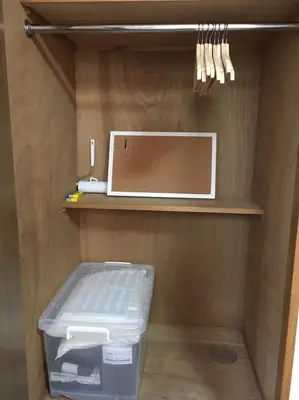 a room with a shelf with a drawer and a box at Tokyo Stay Ikebukuro in Tokyo