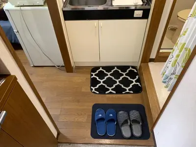 a couple of pairs of flip flops in a small kitchen at Tokyo Stay Ikebukuro in Tokyo