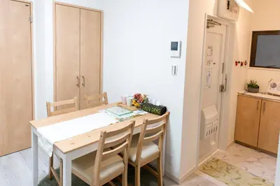 a kitchen and dining room with a table and chairs at ZAITO Tokyo Kikukawa Economy Inn \u5b85\u4e1c\u4e1c\u4eac\u83ca\u5ddd\u6c11\u5bbf in Tokyo