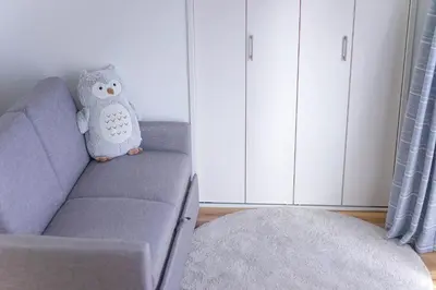 a living room with a couch with a pillow on it at ZAITO Tokyo Kikukawa Economy Inn \u5b85\u4e1c\u4e1c\u4eac\u83ca\u5ddd\u6c11\u5bbf in Tokyo