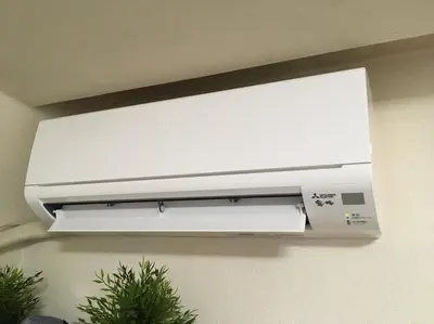a white air conditioner hanging on a wall at Tokyo Stay Rord Shinjuku in Tokyo