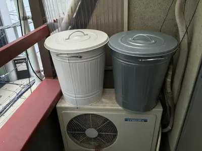 two trash cans sitting on top of a heater at Tokyo Stay Rord Shinjuku in Tokyo