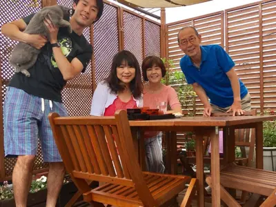 a group of people standing around a wooden table at Ys Bed & Kitchen Tokyo #HY1 in Tokyo