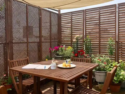 a wooden table with a plate of food on a patio at Ys Bed & Kitchen Tokyo #HY1 in Tokyo
