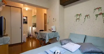 a living room with a blue couch and a table at Cosmo Mercy N-1 / Vacation STAY 12990 in Tokyo