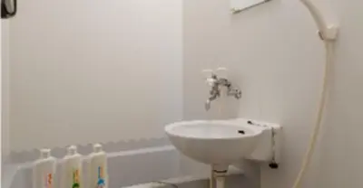 a white bathroom with a sink and a bath tub at Cosmo Mercy N-1 / Vacation STAY 12990 in Tokyo