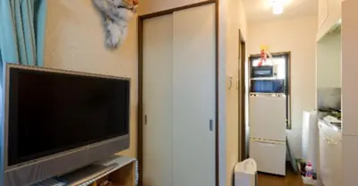 a living room with a flat screen tv and a door at Cosmo Mercy N-1 / Vacation STAY 12990 in Tokyo