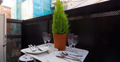 a white table with a potted plant on top of it at Cosmo Mercy N-1 / Vacation STAY 12990 in Tokyo