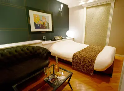 a hotel room with a bed and a couch at Hotel Gran Villa in Tokyo
