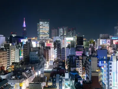 a city skyline at night with lit up buildings at APA Hotel Shinjuku Kabukicho Chuo in Tokyo