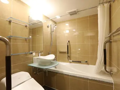 a bathroom with a toilet and a shower and a sink at APA Hotel Shinjuku Kabukicho Chuo in Tokyo