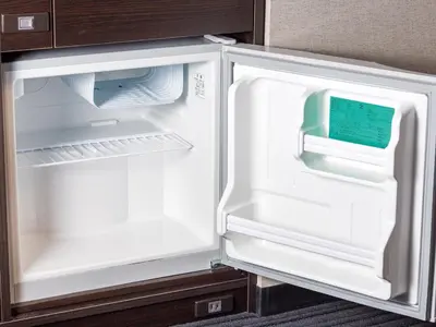 an empty refrigerator with its door open in a kitchen at APA Hotel Shinjuku Kabukicho Chuo in Tokyo