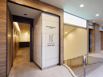 a lobby with a sign on the side of a building at KARIO Sasazuka in Tokyo