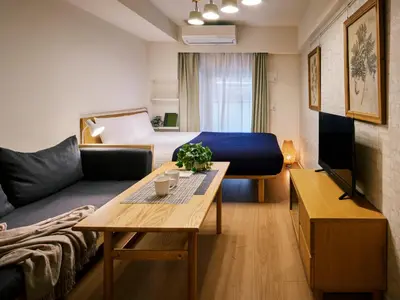 a living room with a couch and a table at KARIO Sasazuka in Tokyo
