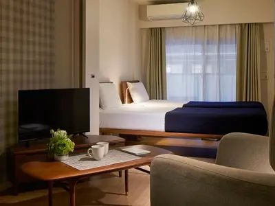 a hotel room with a bed and a tv at KARIO Sasazuka in Tokyo