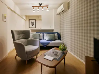 a living room with a couch and a table at KARIO Sasazuka in Tokyo