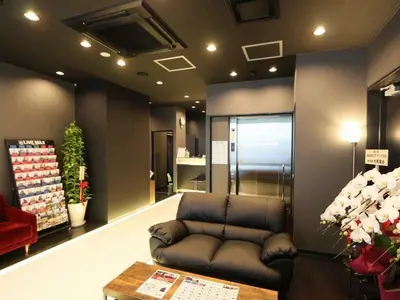 a room with a leather couch in a store at HOTEL LiVEMAX Kayabacho in Tokyo