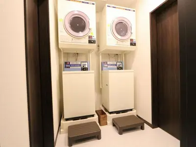 a bathroom with two washing machines in a room at HOTEL LiVEMAX Kayabacho in Tokyo