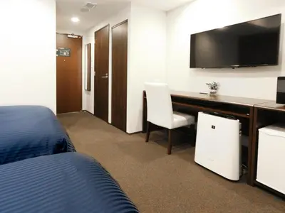 a hotel room with a desk and a tv at HOTEL LiVEMAX Kayabacho in Tokyo