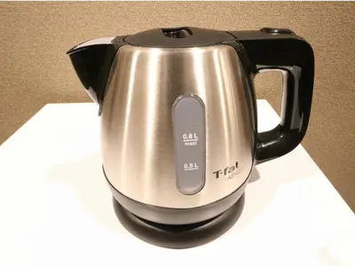 a black and silver tea kettle sitting on a counter at HOTEL LiVEMAX Kayabacho in Tokyo