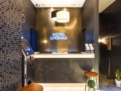 a hotel lobby with a hotel luxembourg sign on the wall at HOTEL LiVEMAX Akasaka in Tokyo