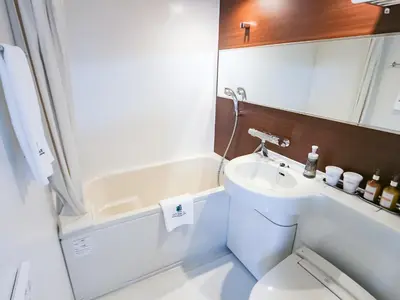 a small bathroom with a toilet and a sink at HOTEL LiVEMAX Akabane-Ekimae in Tokyo