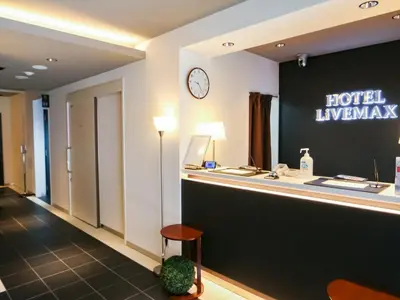 a hotel lobby with a hotel emergency counter and a clock at HOTEL LiVEMAX Akabane-Ekimae in Tokyo
