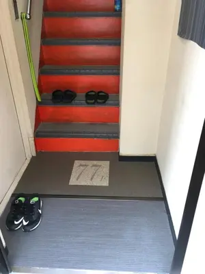 a pair of shoes on the floor next to some stairs at 2F female and lover of man and woman only room in Ueno in Tokyo