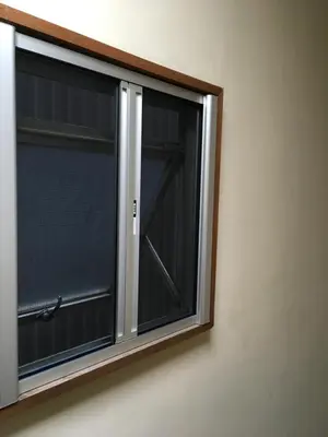 a window with a wooden frame on a wall at 2F female and lover of man and woman only room in Ueno in Tokyo