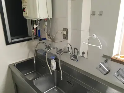 a sink in a kitchen with a water fountain at 2F female and lover of man and woman only room in Ueno in Tokyo