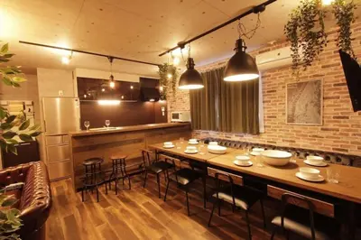 a dining room with a long table and chairs at Shinjuku NY House 1 in Tokyo
