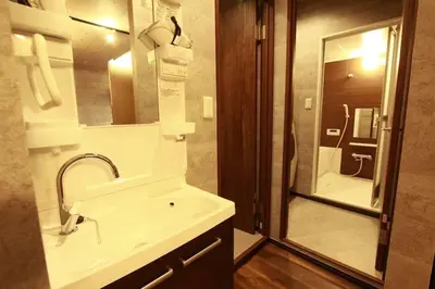 a bathroom with a sink and a shower with a mirror at Shinjuku NY House 1 in Tokyo