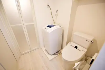 a small bathroom with a toilet and a door at Prime Stage Otsuka Ikebukuro P203 in Tokyo