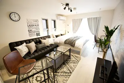 a living room with a couch and a bed at Prime Stage Otsuka/Ikebukuro P201 in Tokyo
