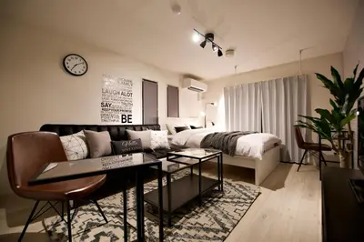 a living room with a couch and a bed at Prime Stage Otsuka/Ikebukuro P201 in Tokyo