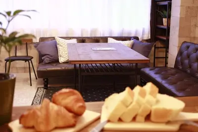 a living room with a couch and a table with pastries at ACT Residence No.1 201 in Tokyo