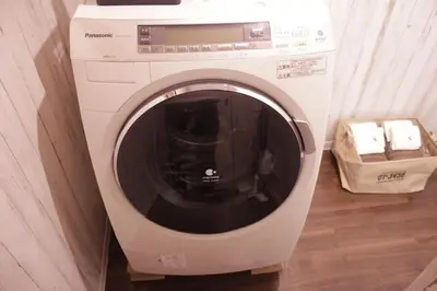 a washing machine is sitting in a room at ACT Residence No.1 201 in Tokyo