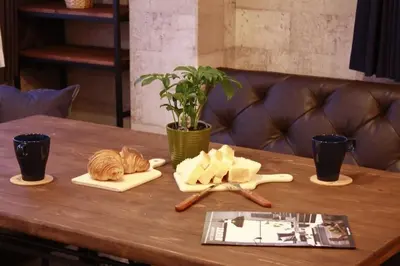 a wooden table with bread and utensils on it at ACT Residence No.1 201 in Tokyo